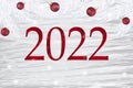 Festive banner 2022 with snow, snowflakes, Christmas decorations. Inscription 2022.